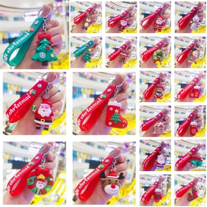 Variety of cartoon Christmas silicone keychains featuring Santa and reindeer on hand straps