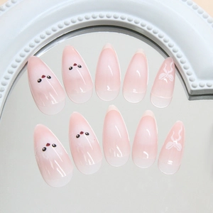 Faux ongles dégradés roses mignons avec motifs d'oiseaux et nœuds blancs élégants