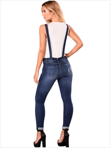 Rear view detail of women's slim-fit denim overalls with back pockets and adjustable straps