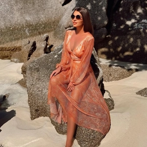 Women's orange mesh V-neck long sleeve beach cover-up with tropical floral swimsuit