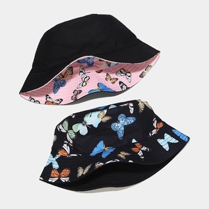 Reversible bucket hat for women with colorful butterfly patterns on black cotton canvas