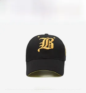 Close-up of golden Gothic B embroidery on a premium black cotton baseball cap