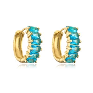 Detail of gold plated hoop earrings with five blue baguette cut cubic zirconia stones