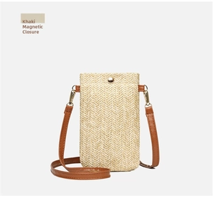 Detail of khaki woven phone bag showing the magnetic buckle closure and brown strap