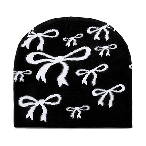 Chic black knitted beanie for women featuring all-over white bow patterns for winter