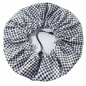 Detail of adjustable drawstring and houndstooth pattern on the waterproof shower cap