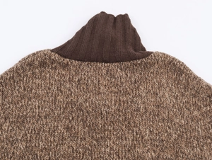 Detail of mixed brown chunky knit sweater with contrasting dark brown ribbed neckline