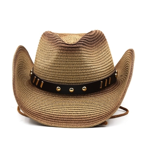 Detail of tan woven cowboy hat featuring faux leather band with gold rivets and studs