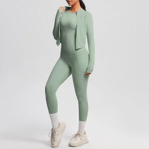 Detail of sage green yoga set showing zip hoodie and pocket leggings fabric texture