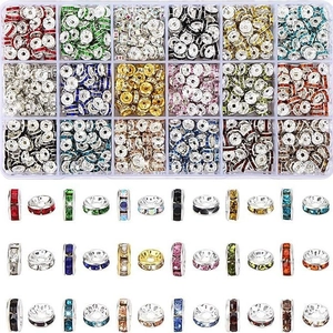 Macro view of 15 colors of crystal rhinestone spacer beads in a clear plastic storage box