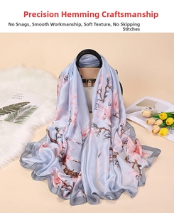 Detailed view of delicate overlock craftsmanship on a light blue floral silk scarf