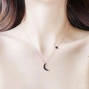 Rose gold moon and star pendant necklace with black micro-pave crystals on a thin chain