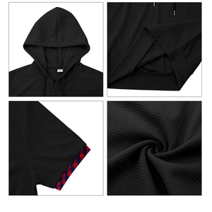 Detail of black waffle knit hoodie showing red plaid cuff lining and fabric texture