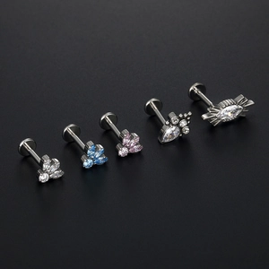 Macro detail of G23 titanium labret studs with zircon inlays in various shapes
