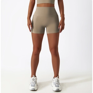 Detail view of khaki high-waisted yoga shorts with side pockets and seamless matte fabric