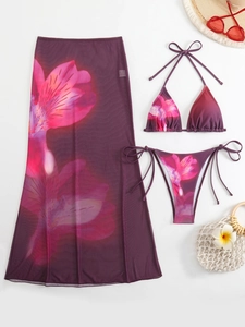 Three-piece floral bikini set with sheer mesh maxi skirt and beach accessories