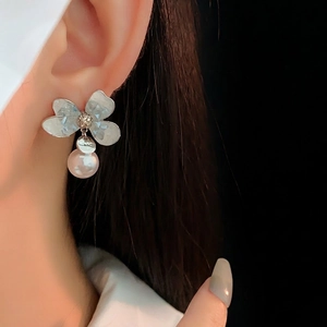 Elegant silver pearl drop earrings with crystal flower petals and tassel design