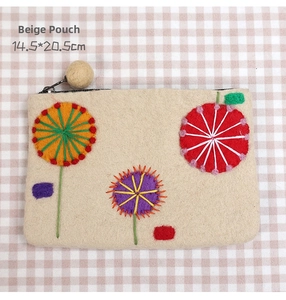 Detail of beige wool felt pouch with handmade floral embroidery and 14.5x20.5cm dimensions