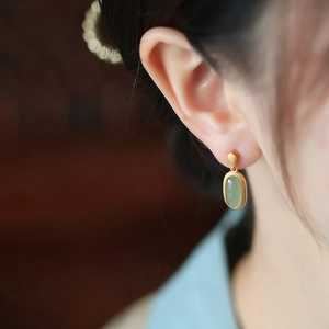 Vintage style gold earrings with green Hetian jade teardrop pendants for elegant women