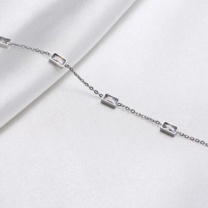 Close-up of rectangular cubic zirconia stones on a delicate titanium steel necklace