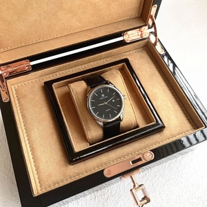 Detailed view of quartz man watch with black dial in a premium wooden gift display case