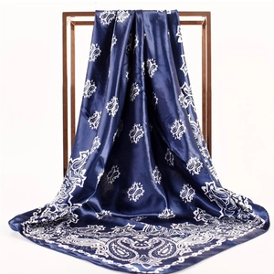 Close-up of elegant paisley print blue satin scarf draped on a metal frame