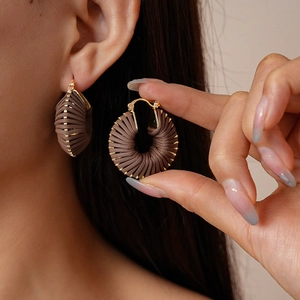 Vintage woven brown leather round hoop earrings with elegant gold accents for women
