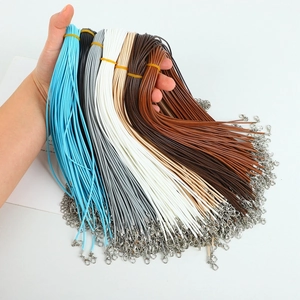 Detail showing assorted colorful wax cord necklaces with silver lobster clasps and chains