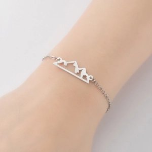 Minimalist stainless steel mountain peak pendant bracelet for women on a model's wrist