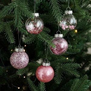 Set of 5 pink Christmas balls with glitter and pearls on a festive green tree branch