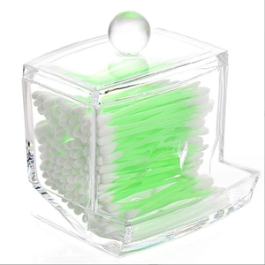 Clear acrylic cotton swab organizer with lid and dispenser slot on white background