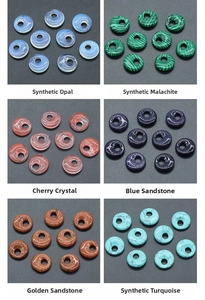 Close-up of six distinct synthetic gemstone donut pendants in various colors and textures