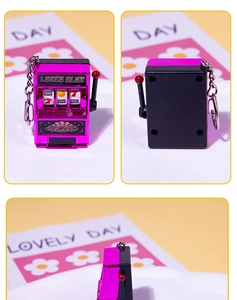 Macro detail of rose gold mini slot machine keychain showing the handle and lucky slot text