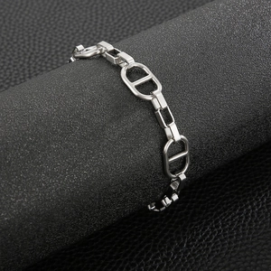 Silver coffee bean link bracelet shown on a premium black leather texture stand