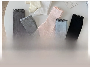 Detailed close-up of ruffle mesh socks in various pastel colors with ribbed texture