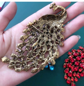 Detailed back view of vintage peacock brooch featuring secure pin closure and gold finish
