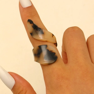 Macro view of geometric tortoise shell acrylic ring with artistic brown resin patterns