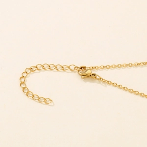 Detailed close-up of golden O-chain necklace with adjustable extension and spring clasp