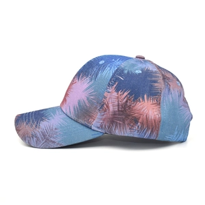 Side view of tie-dye baseball cap with vintage tropical palm leaf embroidery and cotton texture