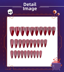 Macro detail of wine red long stiletto press-on nails with 3D Halloween themed patterns