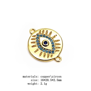 Macro shot of gold-plated copper evil eye connector with blue cubic zirconia stones
