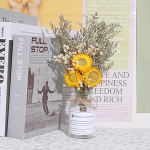 Creative dried flower glass vase with yellow blooms for home decor and photography