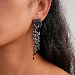 Detail of long black zircon tassel earrings on model showing elegant movement and shine