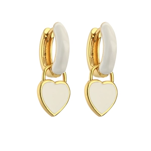 Detail of gold heart earrings with white enamel finish and polished metal hoop