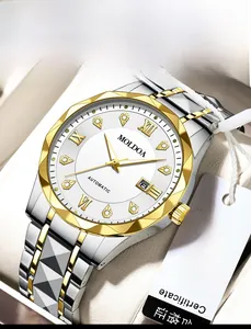 Detailed close-up of two-tone stainless steel watch with golden faceted bezel and date window