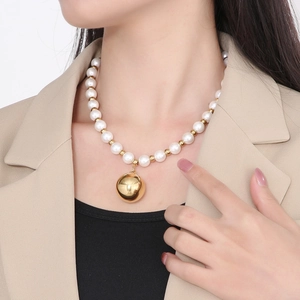 French style pearl necklace with gold bead pendant on a model against white background