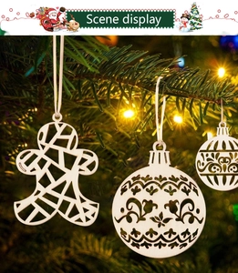 Close-up of wooden hollow Christmas ornaments hanging on a lighted tree for festive DIY decor
