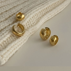 925 silver golden geometric hoop earrings in various sizes on soft knit fabric