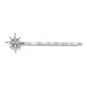 Detailed view of silver hair pin featuring a sparkling rhinestone starburst ornament