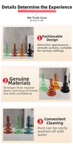 Close-up of stacked spherical borosilicate glass candle holders in multiple colors